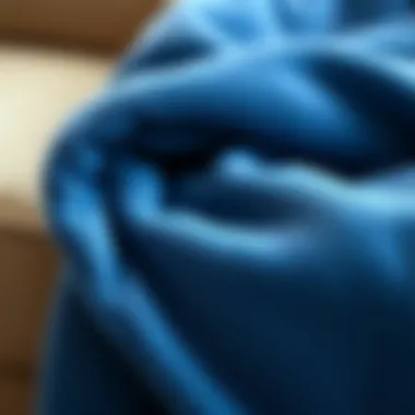 Close-up of a soft fabric blue throw blanket, highlighting texture and material